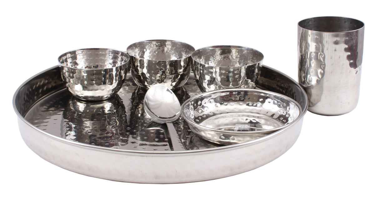 http://www.indianartvilla.com/cdn/shop/products/steel-hammer-7-piece-thali-set-1-thali-12-3-bowl-1-halwa-plate-1-dessert-spoon-1-flat-hammered-glass-steel-dinner-sets-ss-5-333159_1200x1200.JPG?v=1586629690